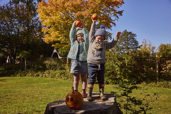 Image shows two children with pumpkins at the Borde Hill Halloween trail, just outside of Brighton.